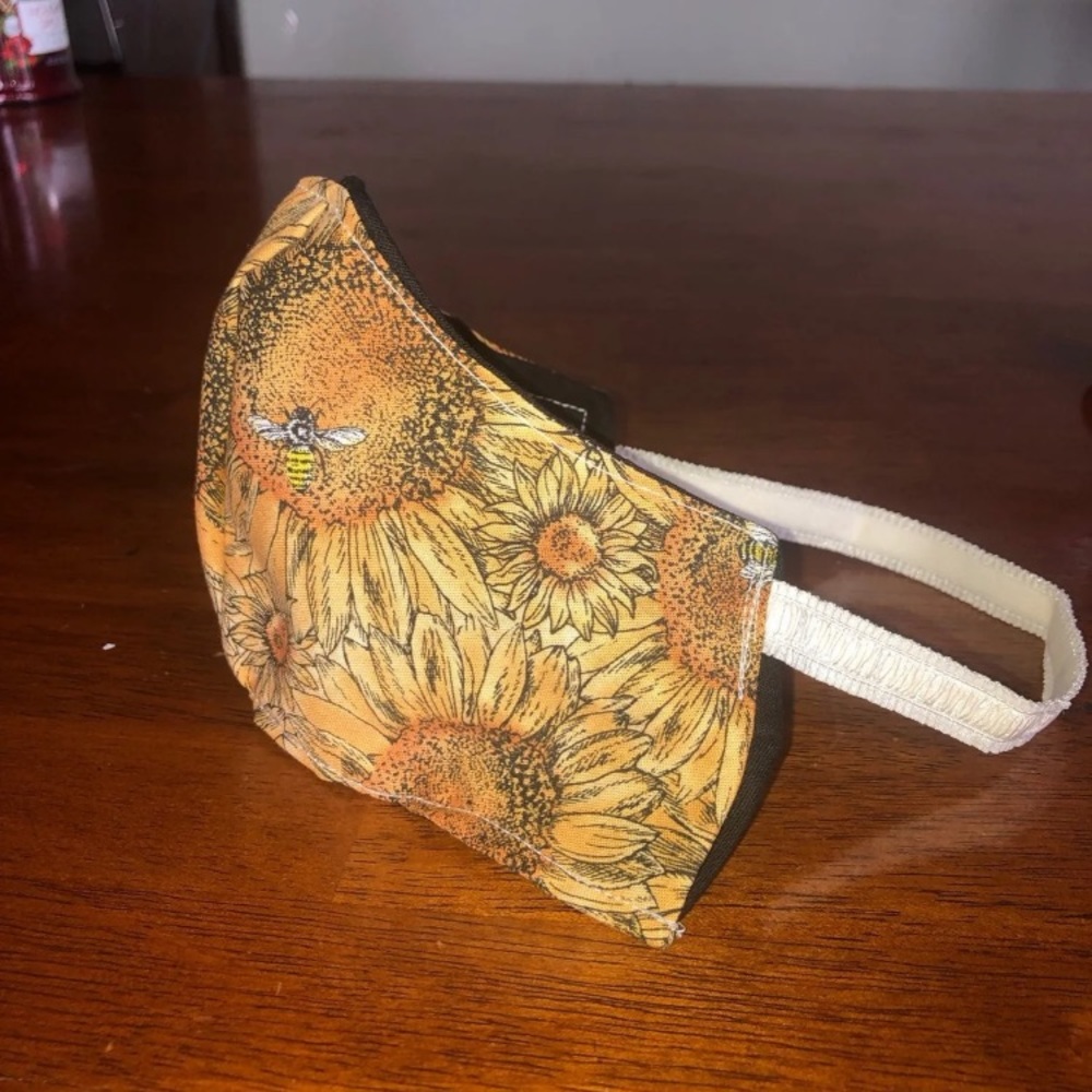 Sunflower handmade face mask behind head elastic